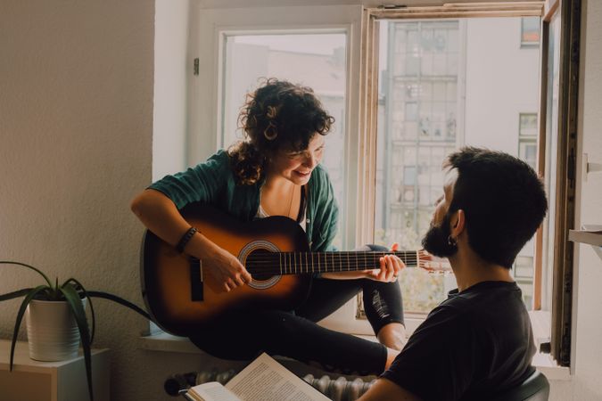 Cheerful couple spending time together at home