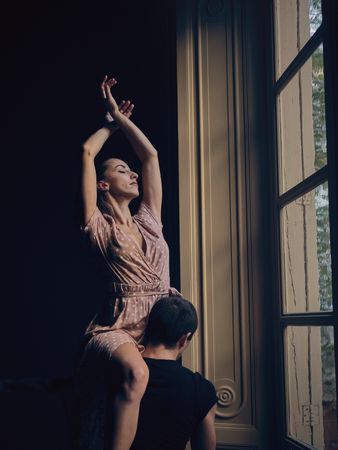 Graceful ballerina on shoulder of dance partner