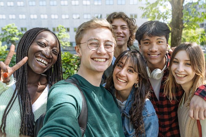 Portrait of multi-ethnic group of students hanging out on campus