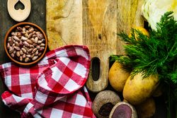 Pinto beans, potatoes and dill on kitchen counter