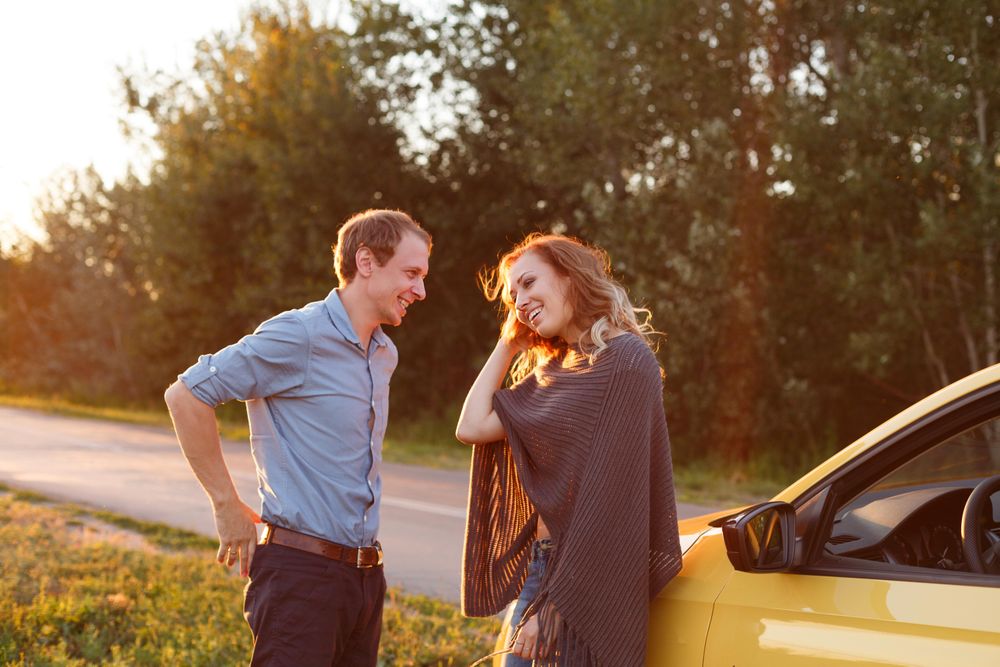 Couple talk and rest on the side of the quiet road