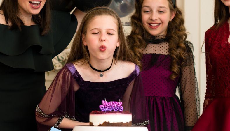 Girl blowing out birthday candles