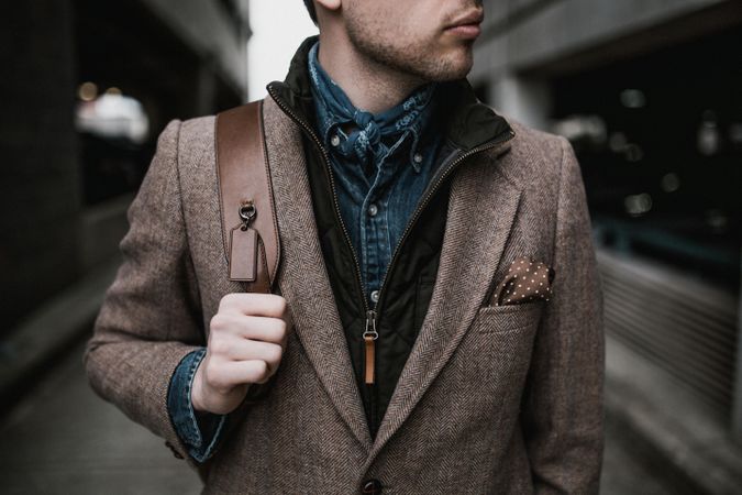 Man in brown coat standing outdoor