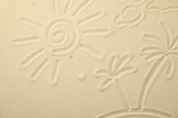 Sea sand with painted sun, clouds and palms on island