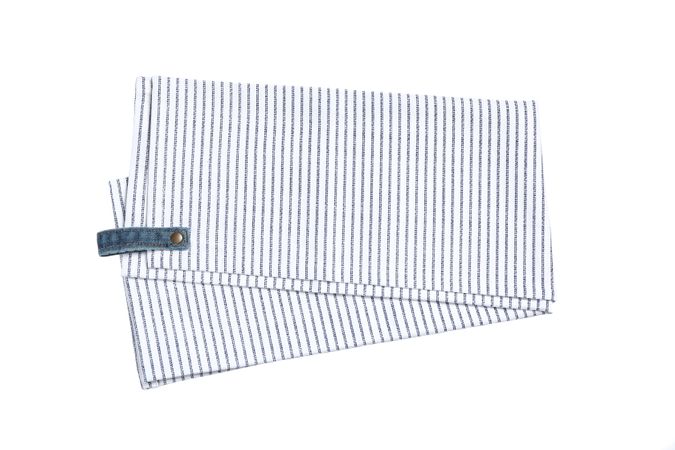 Folded fabric napkin isolated on plain background