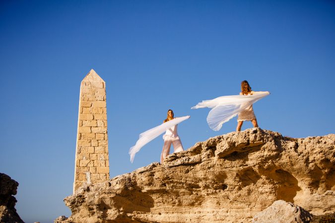 Young women with textile on stone