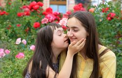 Two sisters being affectionate together