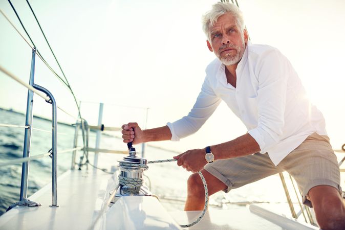 Man working on yacht on sunny day