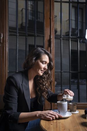 Woman drinking coffee latte in coffee shop