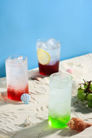Various Lemonade Summer Drink on Beach Sand Setting