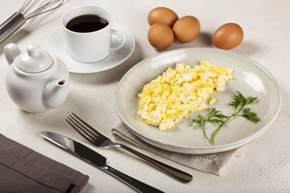 Breakfast with scrambled eggs on the table.