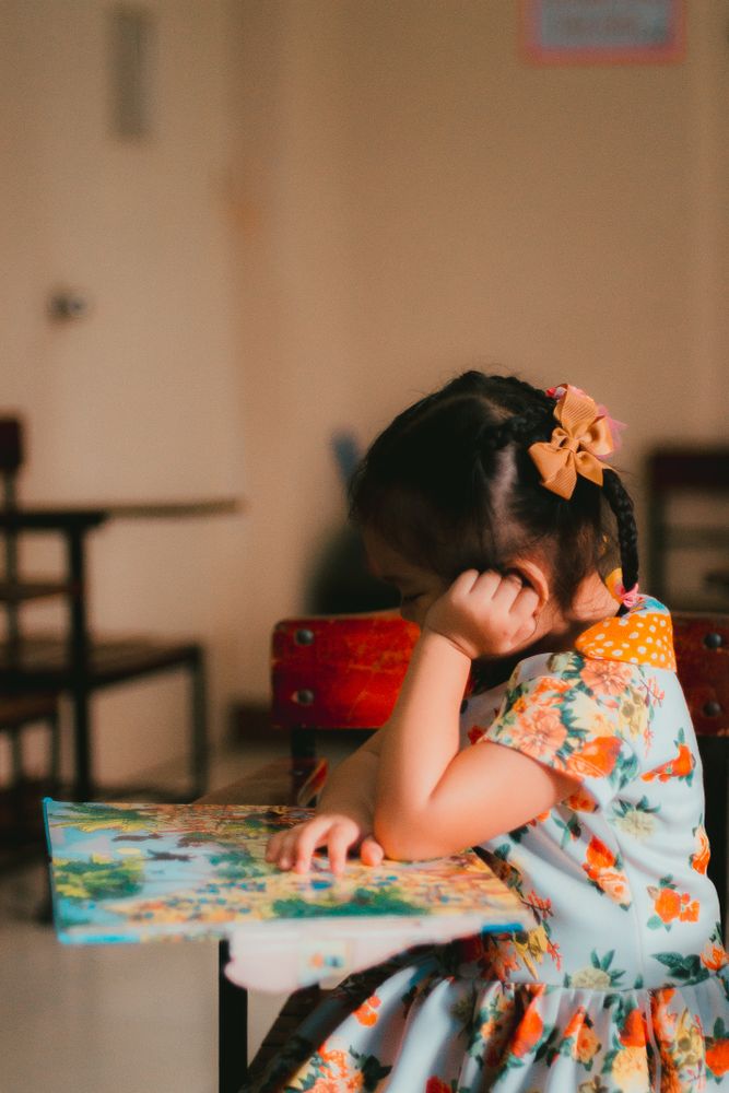 Girl sitting at a desk in classroom