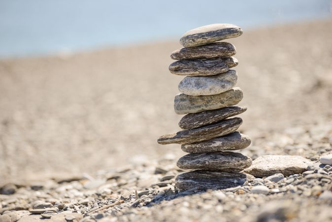 Pebbles balancing on the sandy beach