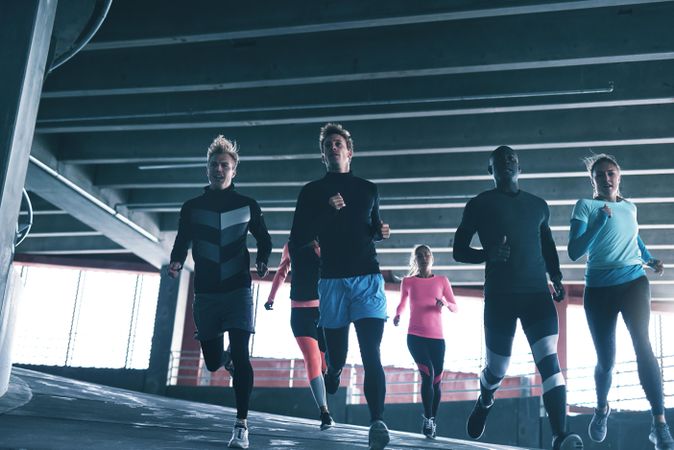 Group of runners jogging down a decline