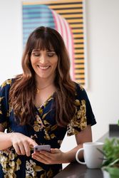 Transgender woman smiling at phone