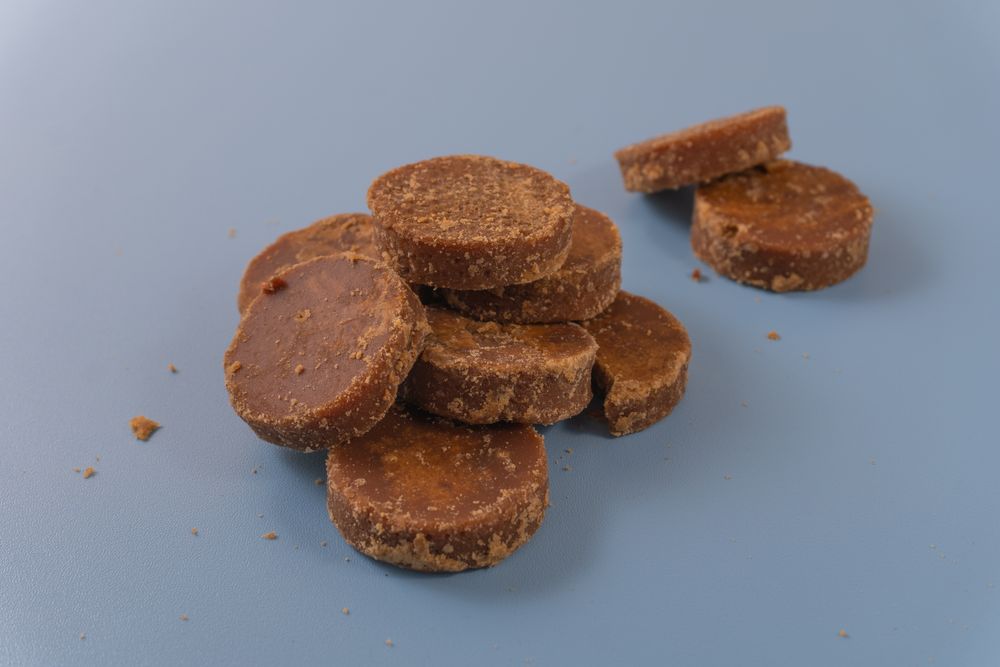 A stack of traditional palm sugar (gula merah) blocks arranged neatly