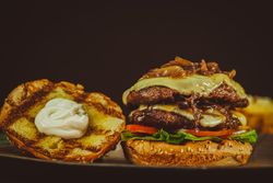 Side view of double cheeseburger with mayo