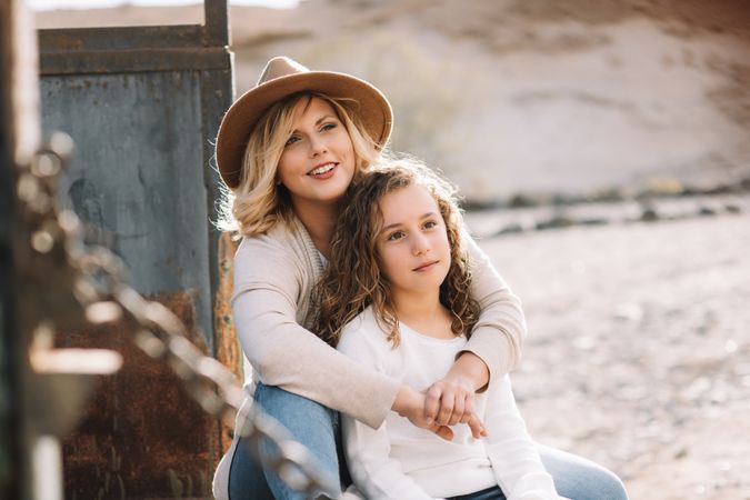 Mother hugging girl in truck body