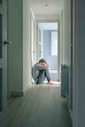 Man crying in hallway