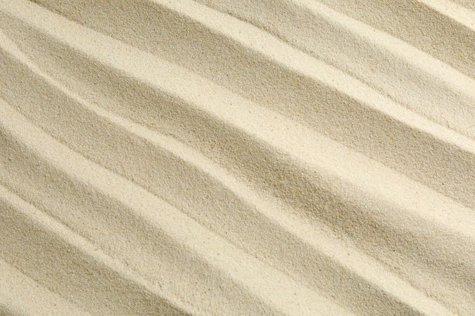 Clear sea sand as background, space for text and closeup. Summer vacation background