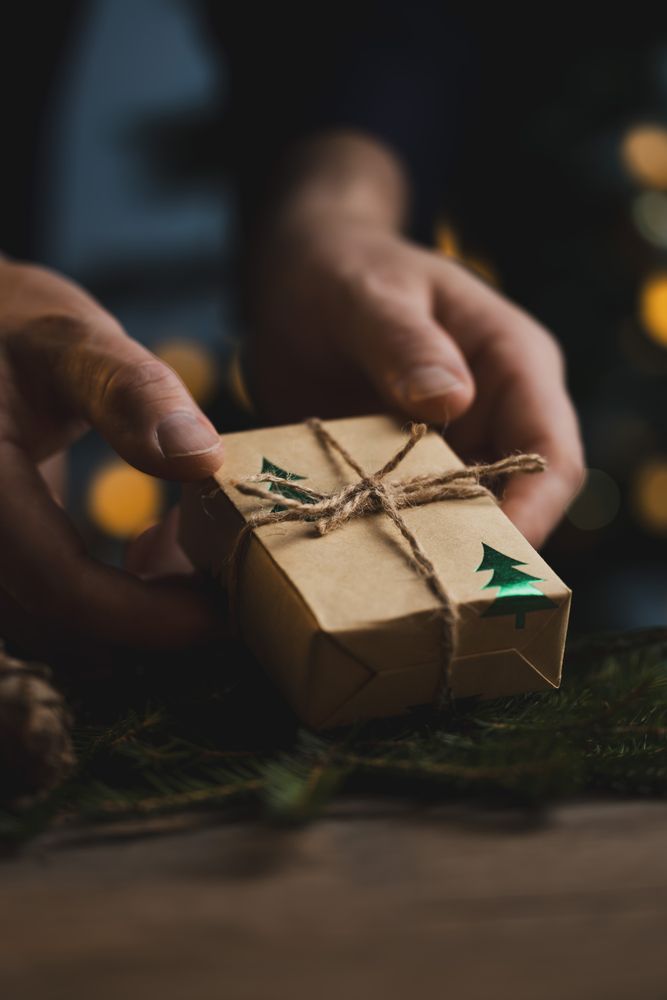 Man holding Christmas gift in hands