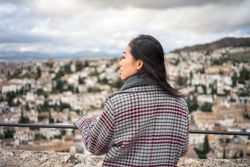 Cheerful woman visiting ancient city