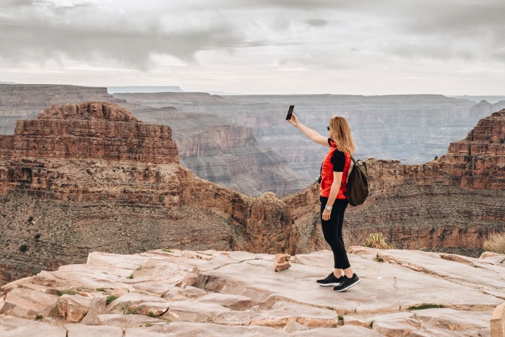 Active female photographing pictorial landscape