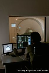 Person using computer monitor beside MRI room 4BY8E5