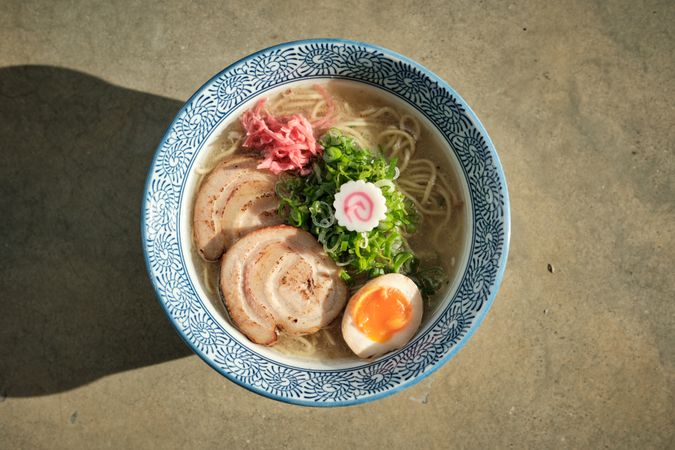 Appetizing ramen soup in ceramic bowl