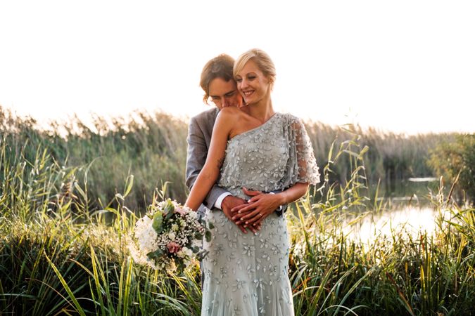 Happy newly wedded couple delighting in event at nature