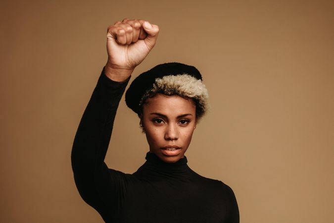 Black woman protesting against racism with raised fist