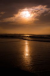 Beautiful evening sky over waving sea and shore