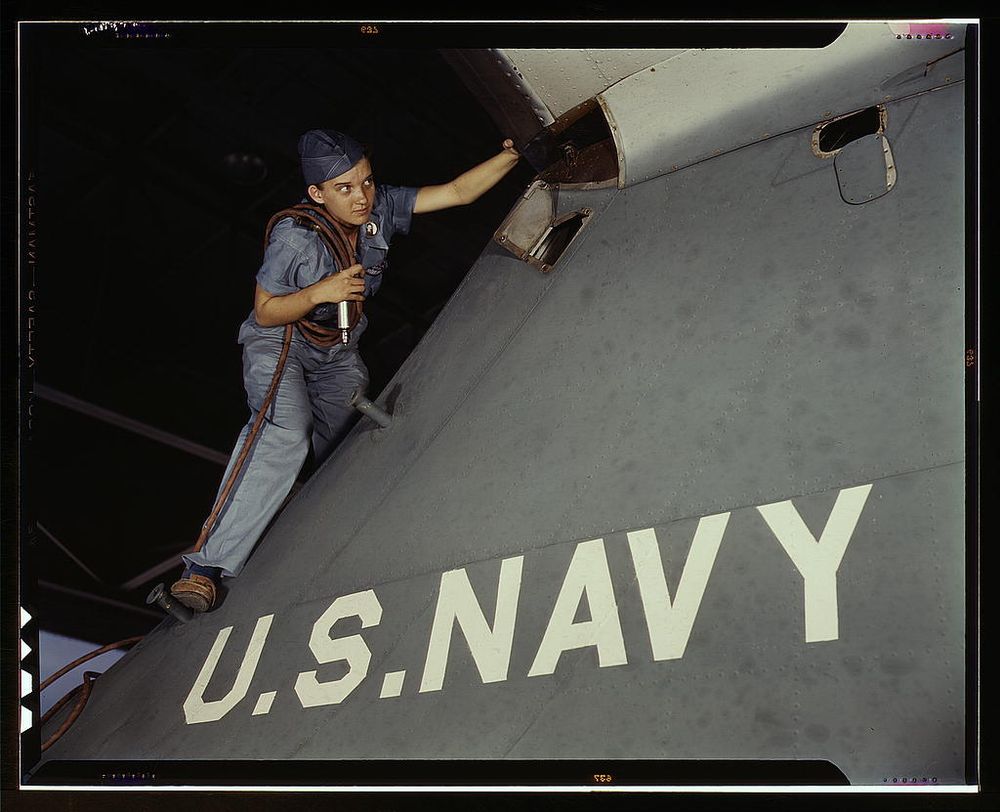 Corpus Christi, TX, USA - 1942: Woman scaling a plane at a Naval Air Base