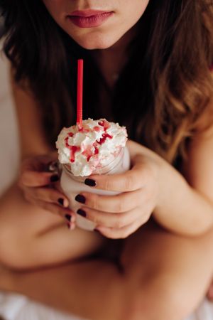 Woman holding glass with tasty drink