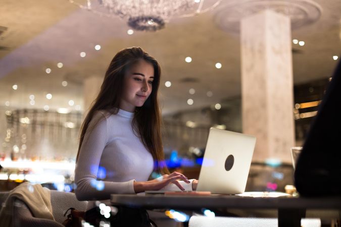 Young brunette woman working on her laptop