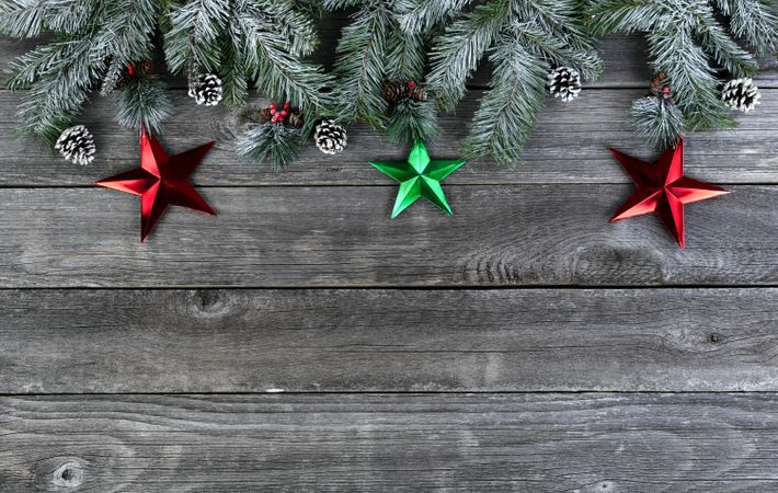 Snowy fir with stars on age wooden planks