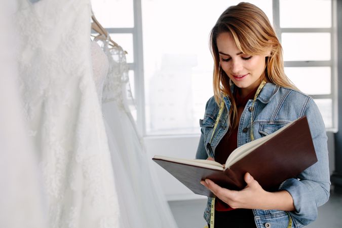 Woman with a diary in her bridal boutique
