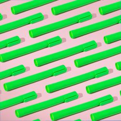 Rows of green highlighter on pink background with shadow