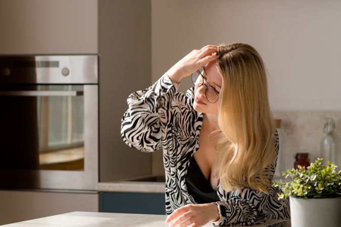 Woman adjusting hair in thought