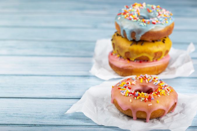 Delicious assorted colorful donuts on the table.