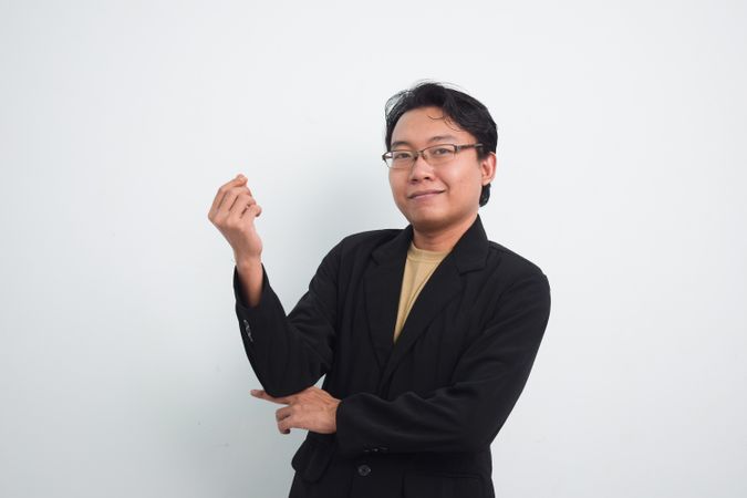 Asian Businessman asking for money with hand sign