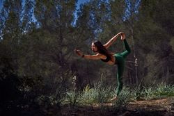 Hispanic doing Standing bow in nature