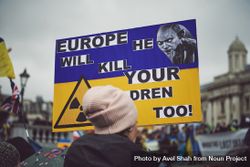 London, England, United Kingdom - March 5 2022: Woman with Ukrainian flag sign in Trafalgar Square 0gwA70