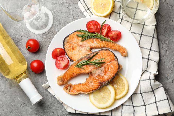Composition with tasty grilled salmon on gray background, top view