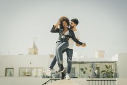 Young couple having fun on street