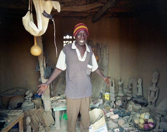 Dogon country, Mali - Mar 10, 2007 - Malian artisan showing wares