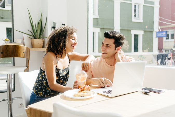 Happy diverse couple resting in restaurant