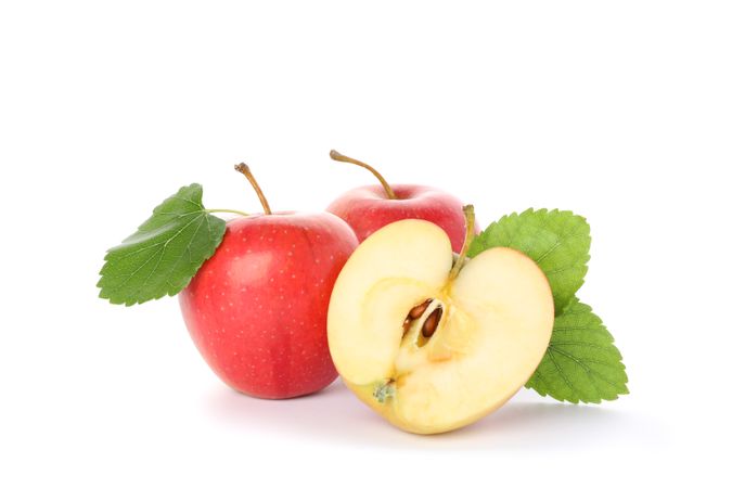 Sweet apples with leaves isolated on light background