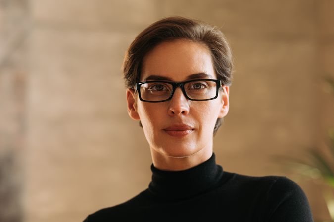 Woman in turtle neck and square glasses