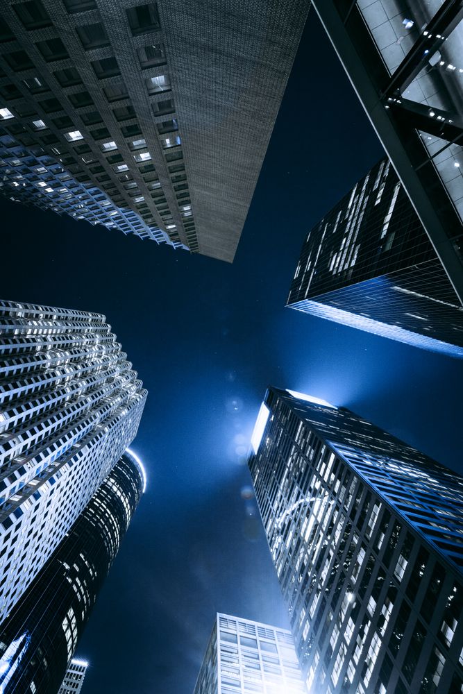 Bottom view of high rise buildings by night